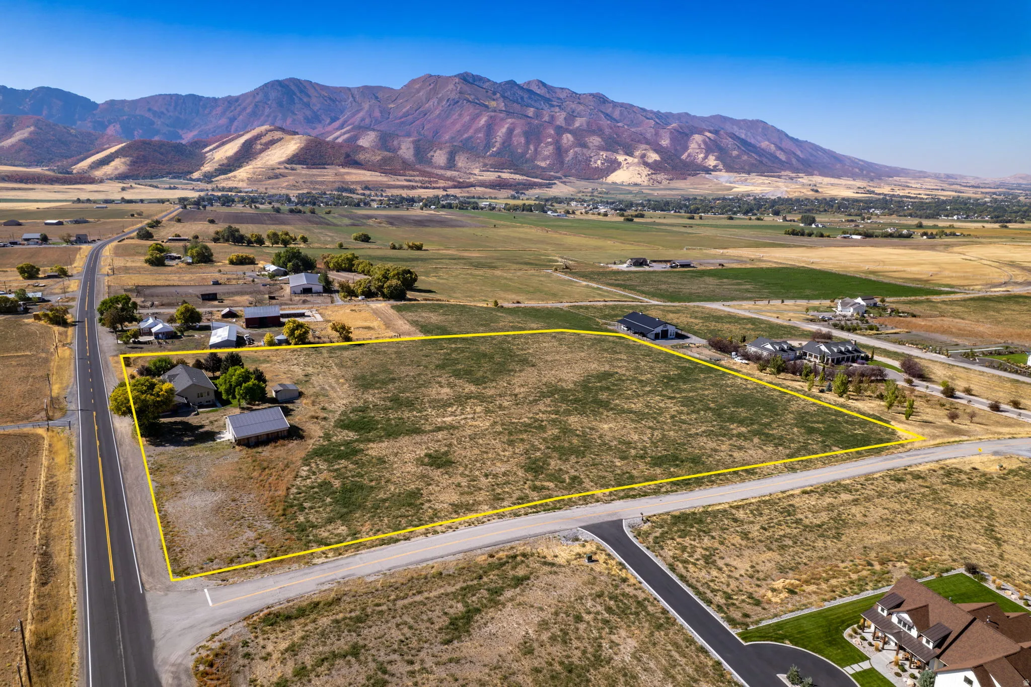 Expansive lot featuring a primary residence, a secondary detached structure, and established surrounding roads