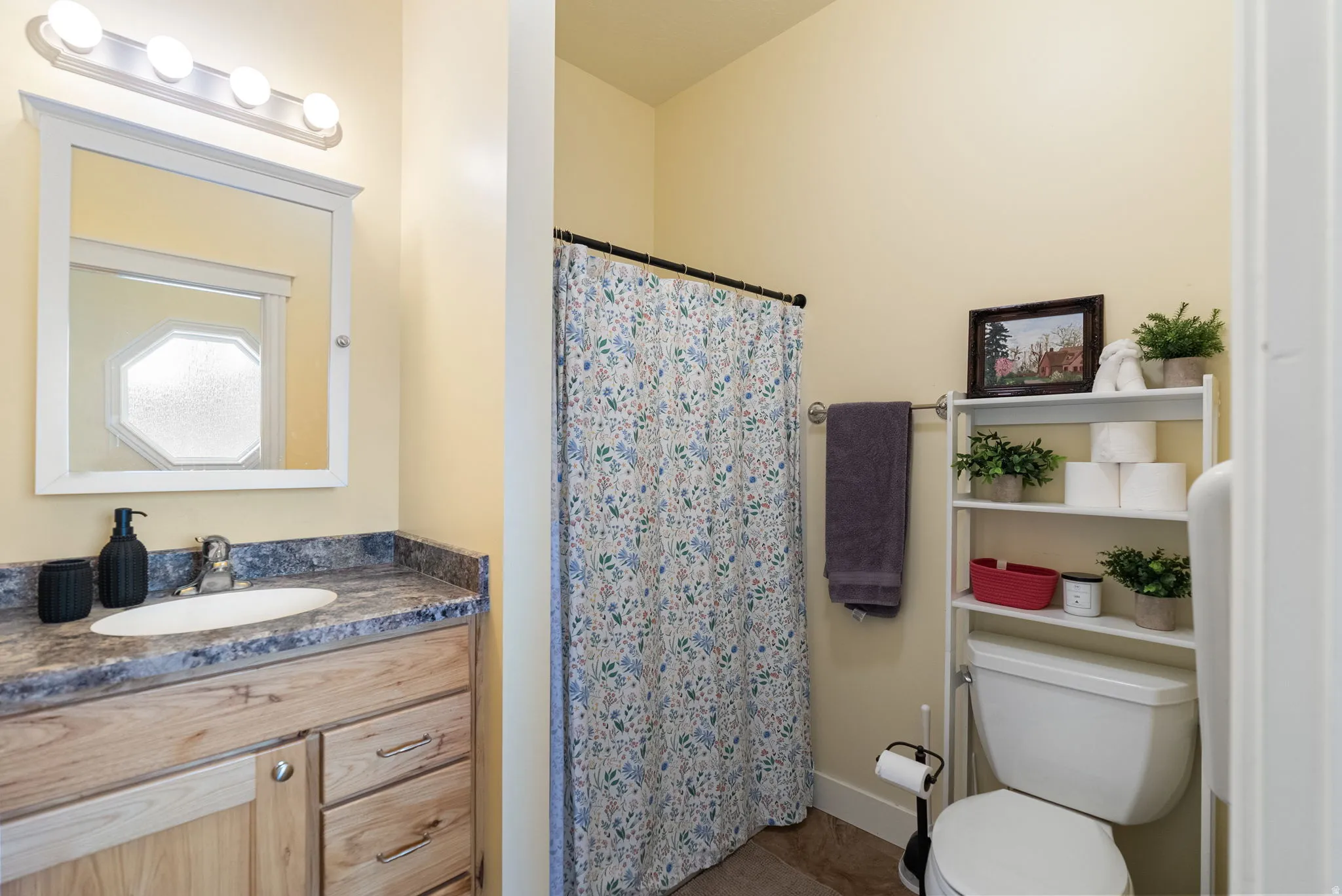 Wood-finish vanity with an integrated sink and laminate countertop
