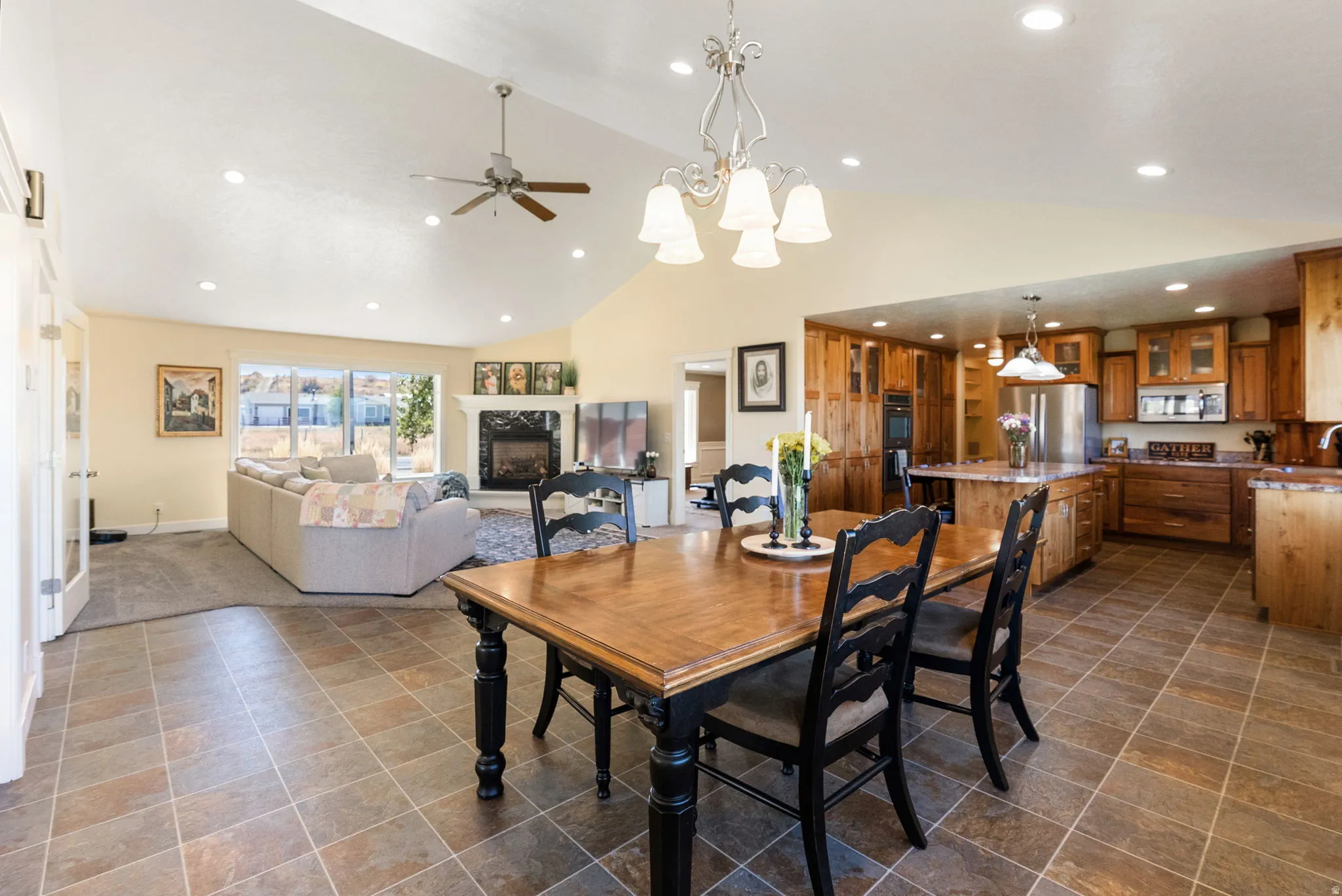 Vaulted ceilings featuring recessed lighting, a ceiling fan, and a chandelier