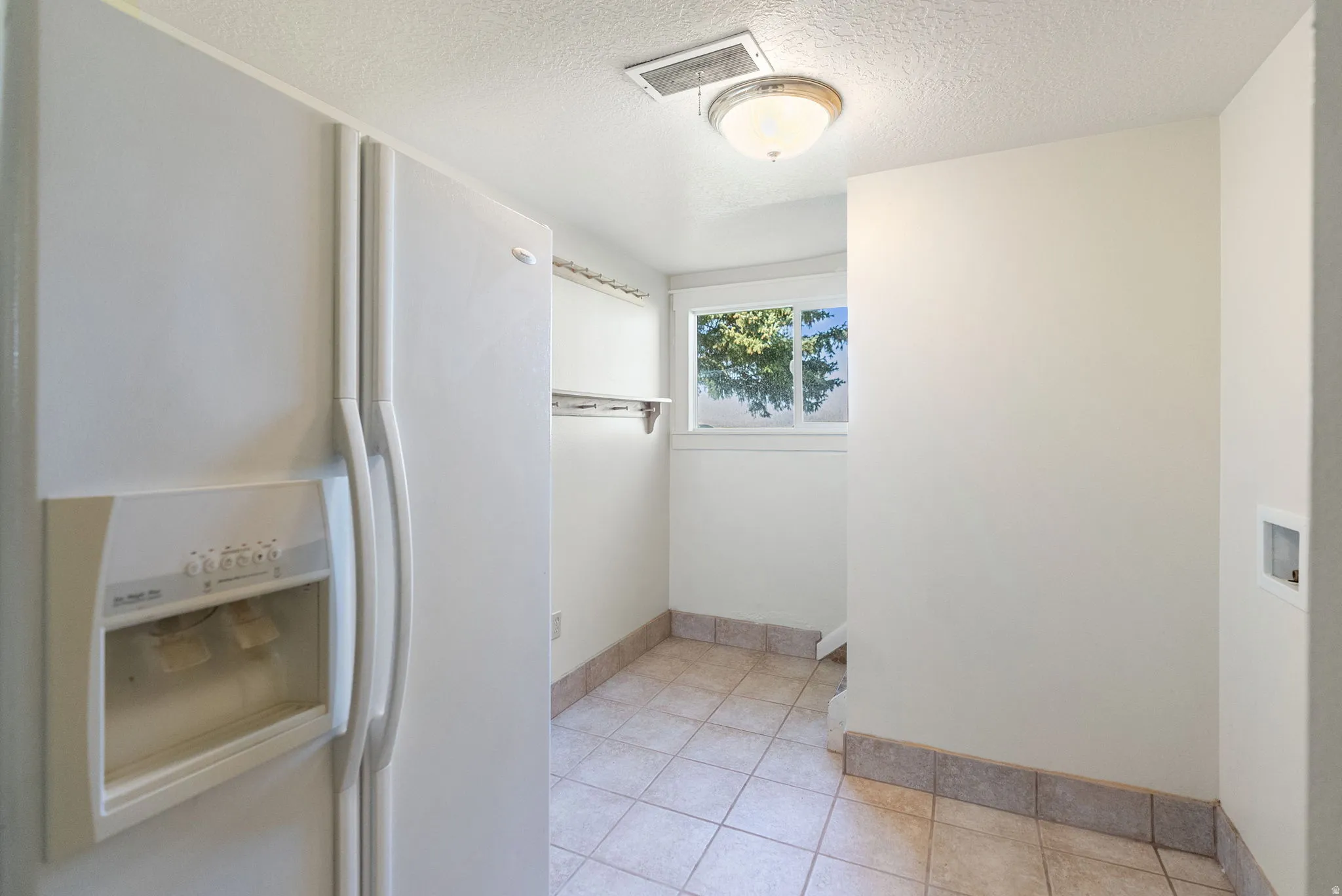 Tile flooring, window, built-in shelving, ceiling-mounted light fixture, white walls