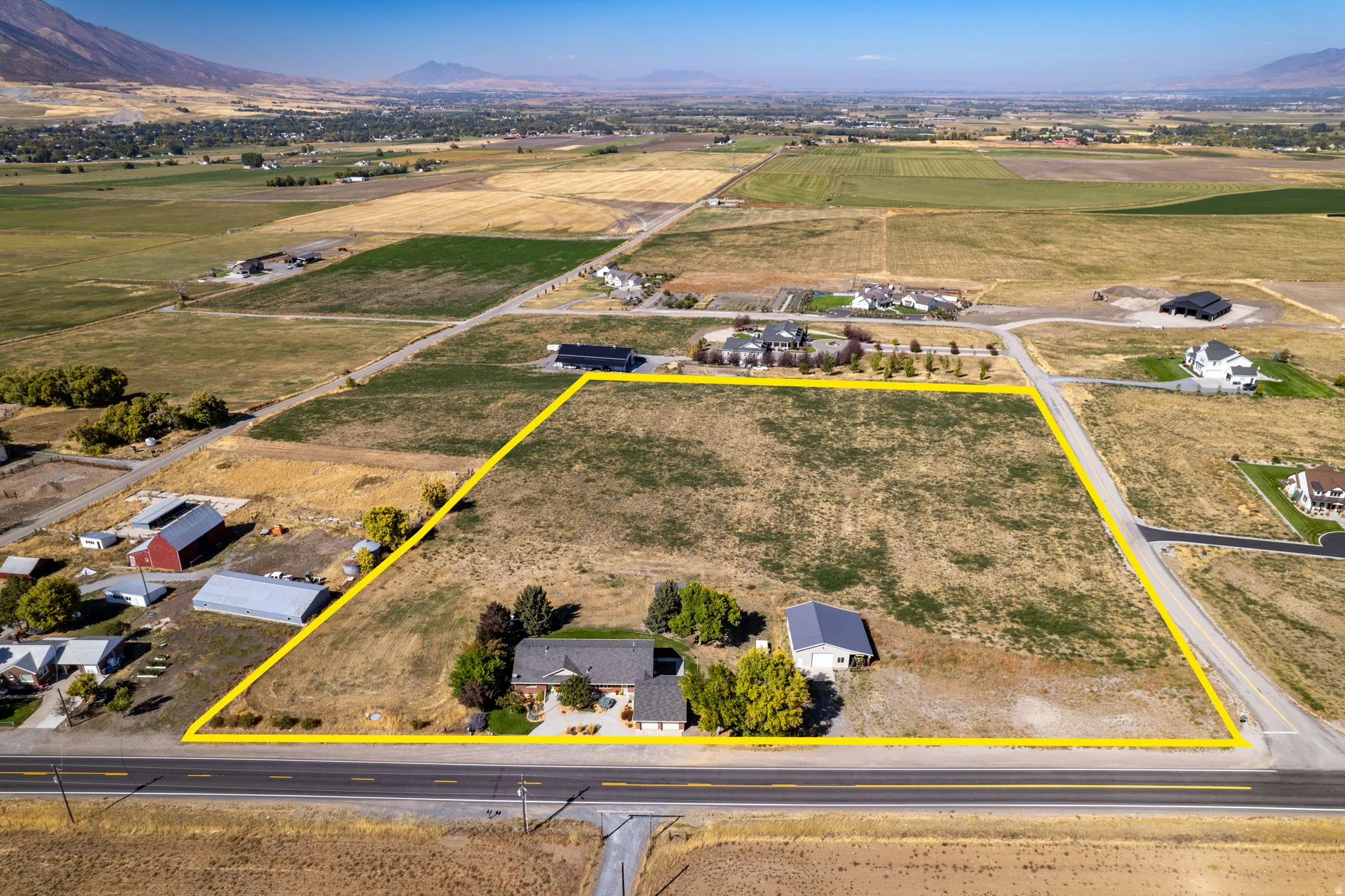 Expansive parcel featuring a main residence, an accessory building, and substantial open land