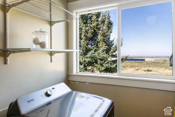 Slider window with a distant landscape, wire shelving, and a neutral wall finish