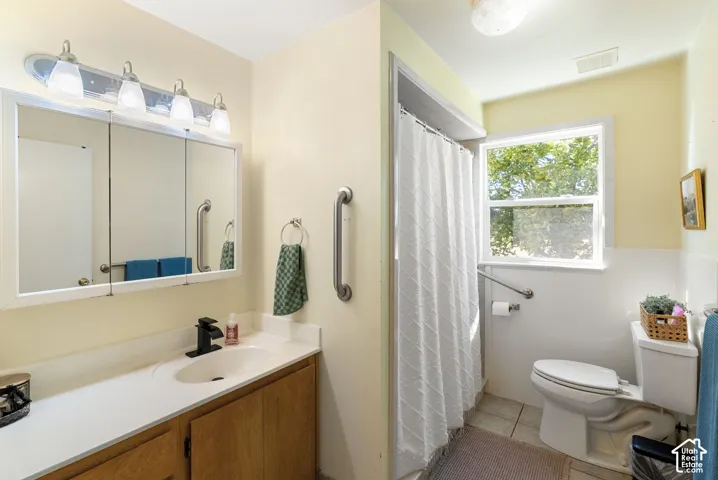 Vanity with a solid surface countertop, wood-finish cabinetry, and a framed medicine cabinet