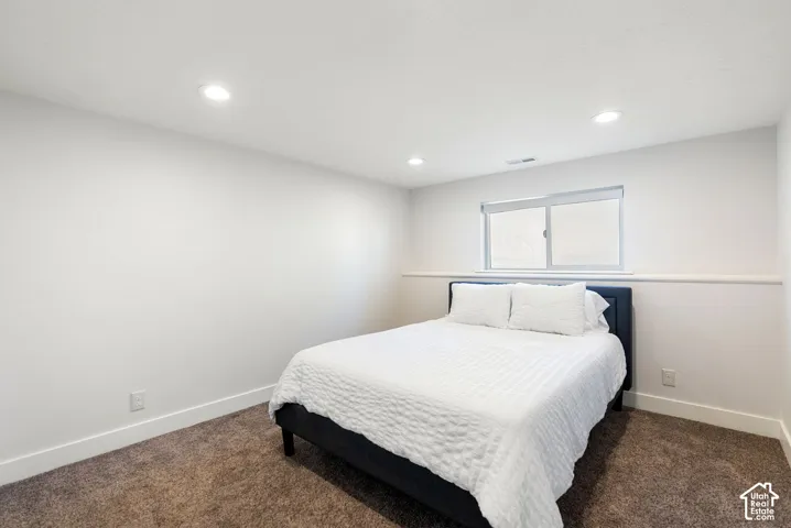 Recessed ceiling lighting, neutral paint, single window, and carpeted flooring