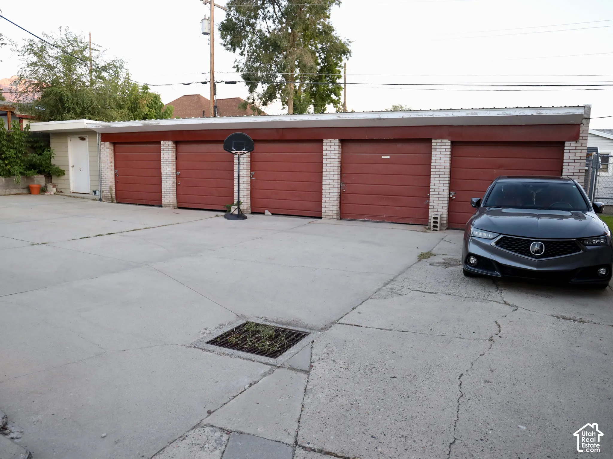 Five individual garage doors with brick accents