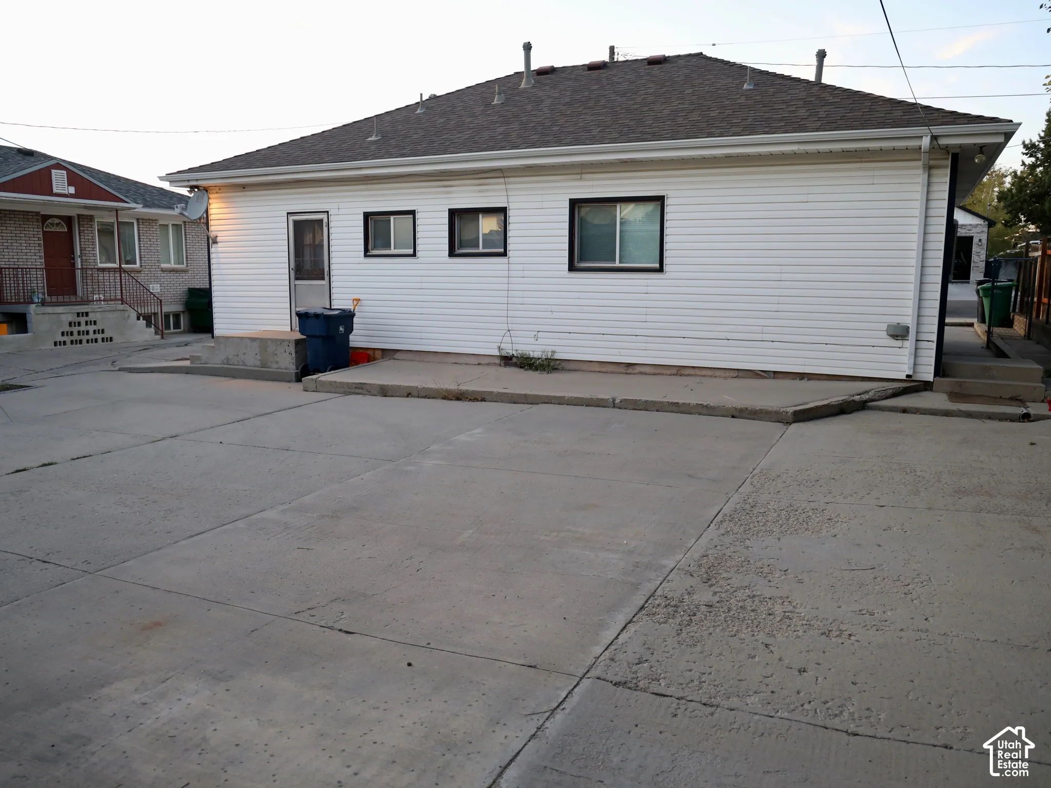 White siding exterior with a dark shingle roof