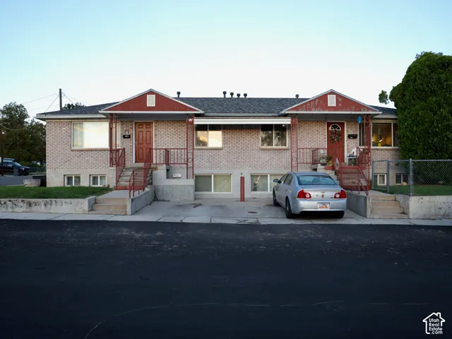 Brick exterior with red trim accents, covered entryways, and concrete steps