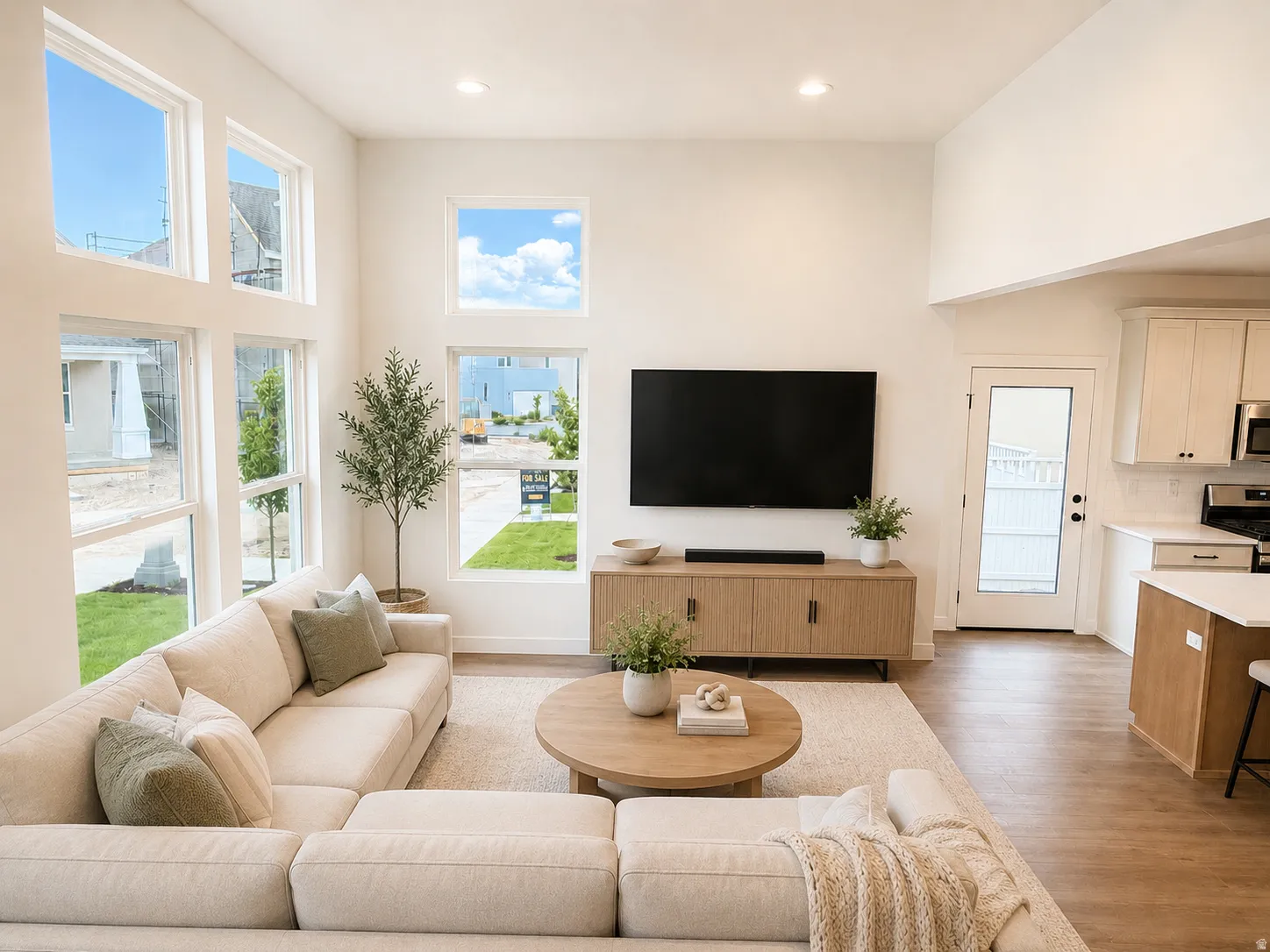 Vaulted ceiling, recessed lighting, wood-finish flooring, white cabinetry, and white countertops