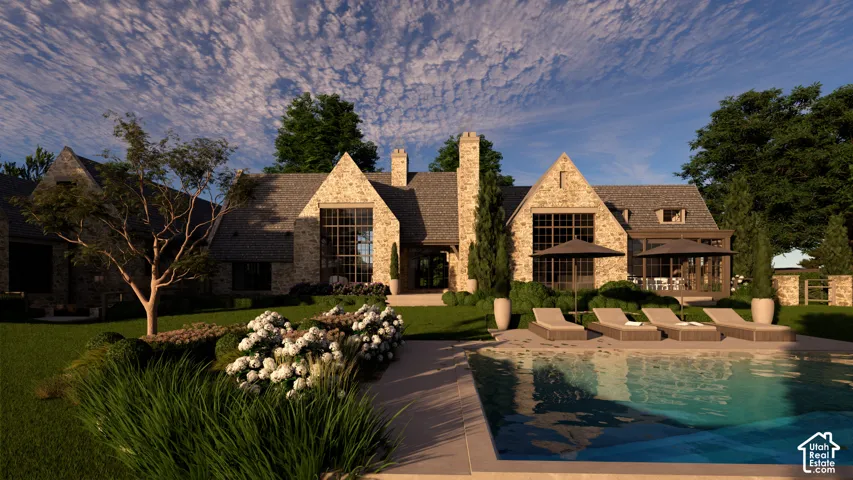 Stone facade with multiple gables and dormers, large grid windows, expansive lawn, and an integrated swimming pool with a surrounding patio