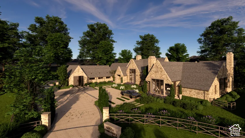 Stone exterior with multiple gabled rooflines, a paved driveway, and established perimeter trees