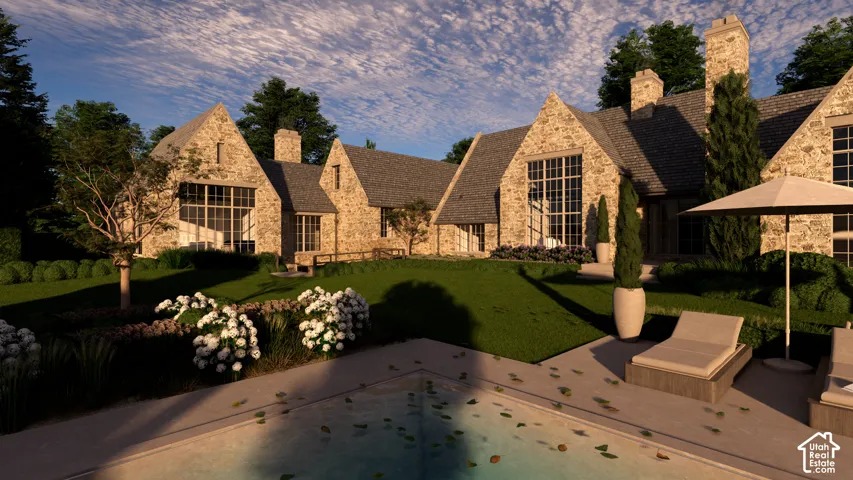 Stone exterior with multiple gables, extensive landscaping, and a rectangular swimming pool with an integrated concrete surround