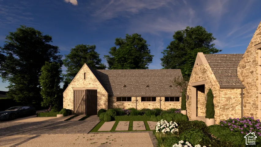 Stone facade with gabled roof lines, featuring wood-finish garage doors and multiple windows