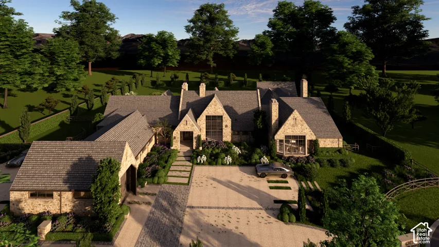 Stone facade residence featuring a multi-gabled roofline, extensive paved driveway, and integrated two-car garage