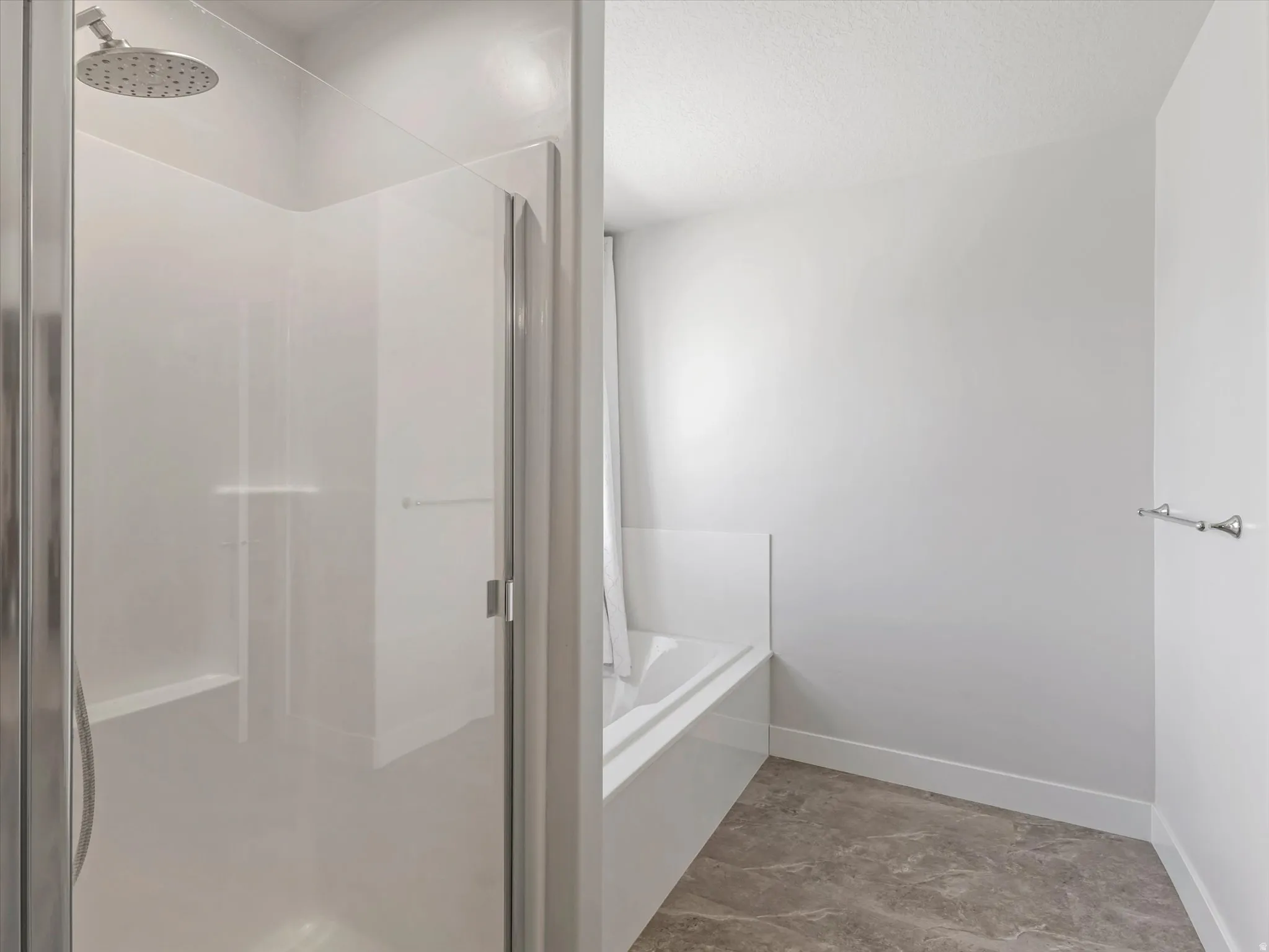 Walk-in shower with clear glass enclosure and built-in bench