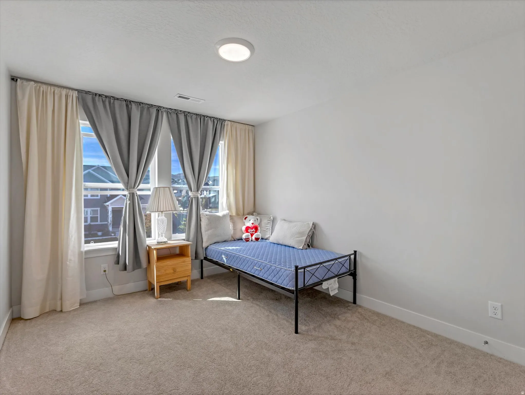 Wall-to-wall carpeting with light-toned walls and trim