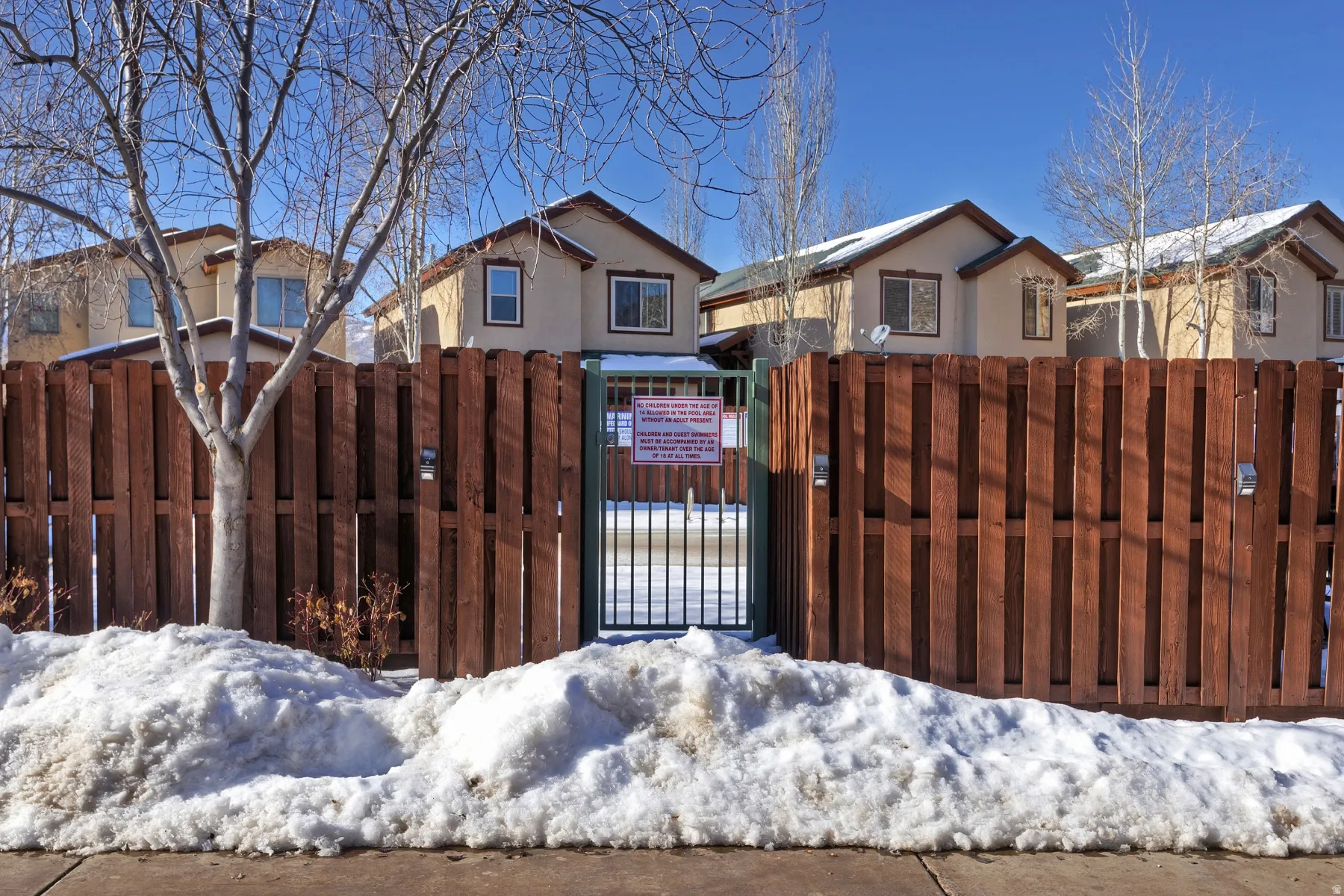 Wood fence with a metal gate entrance