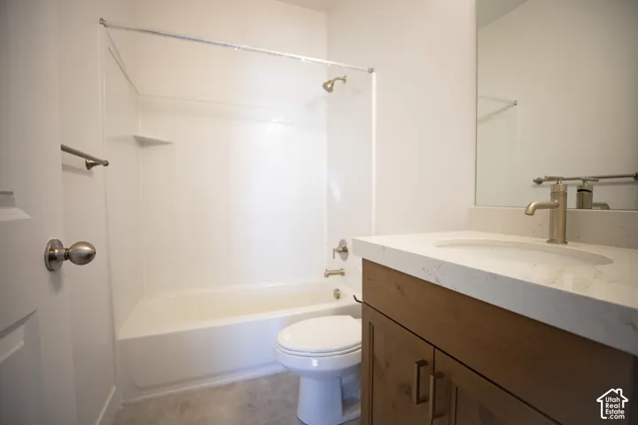 Full secondary bath with stained wood cabinets and quartz slab countertops.