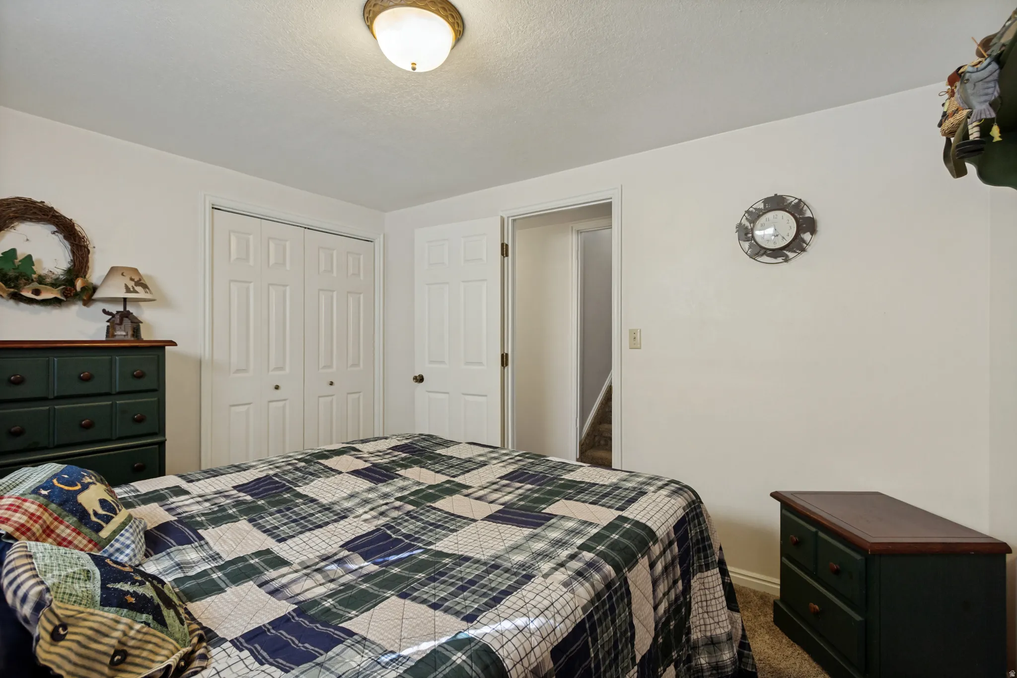 White paneled closet doors, neutral wall paint, and a semi-flush mount ceiling light