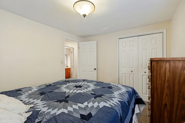 Recessed lighting fixture, paneled bi-fold closet doors, and light-colored walls
