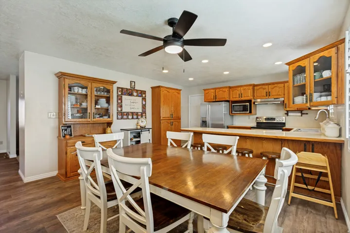 Kitchen featuring wood-finish cabinetry, stainless steel appliances, and recessed lighting