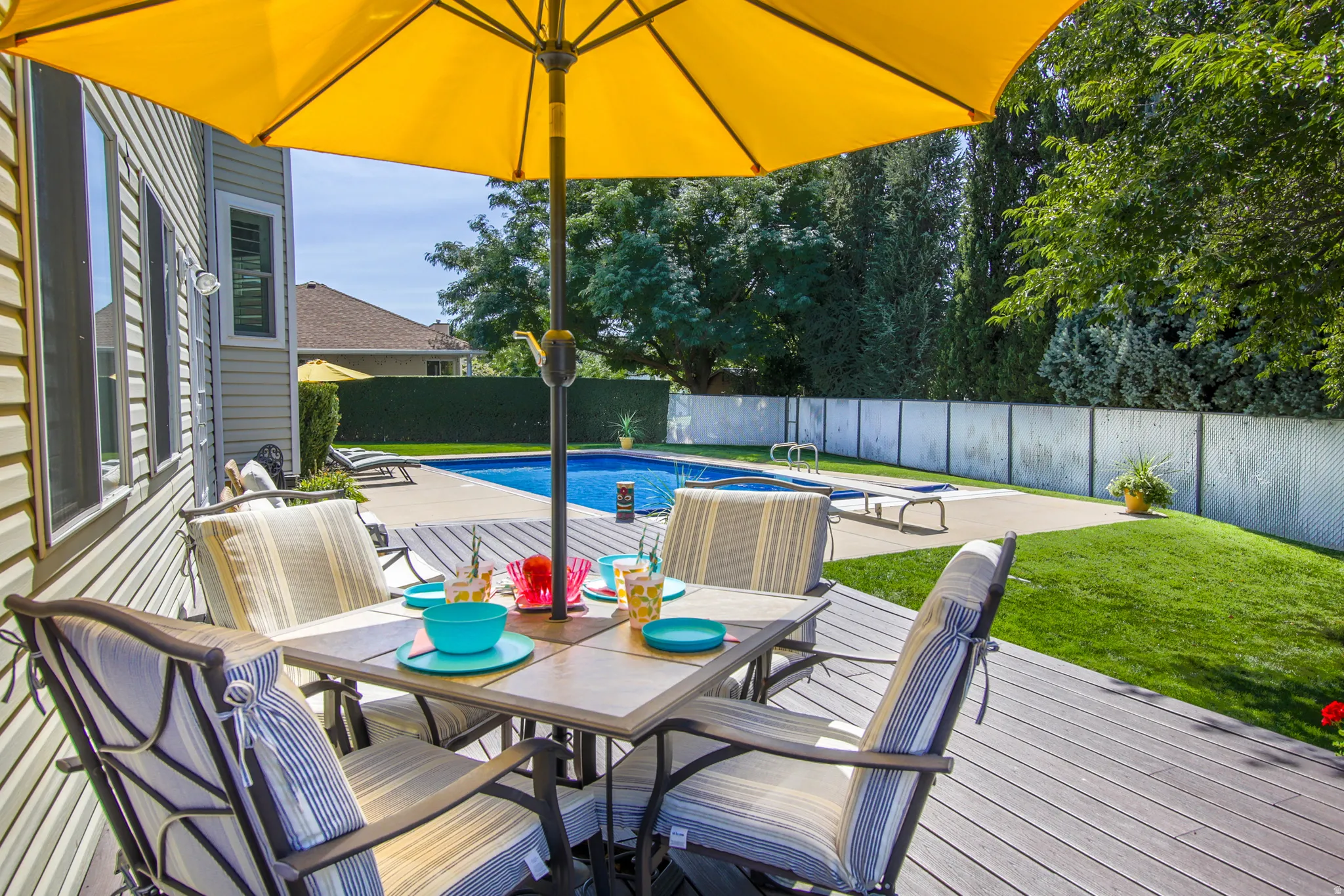 You're going to love this Expansive deck with an in-ground swimming pool and surrounding concrete patio