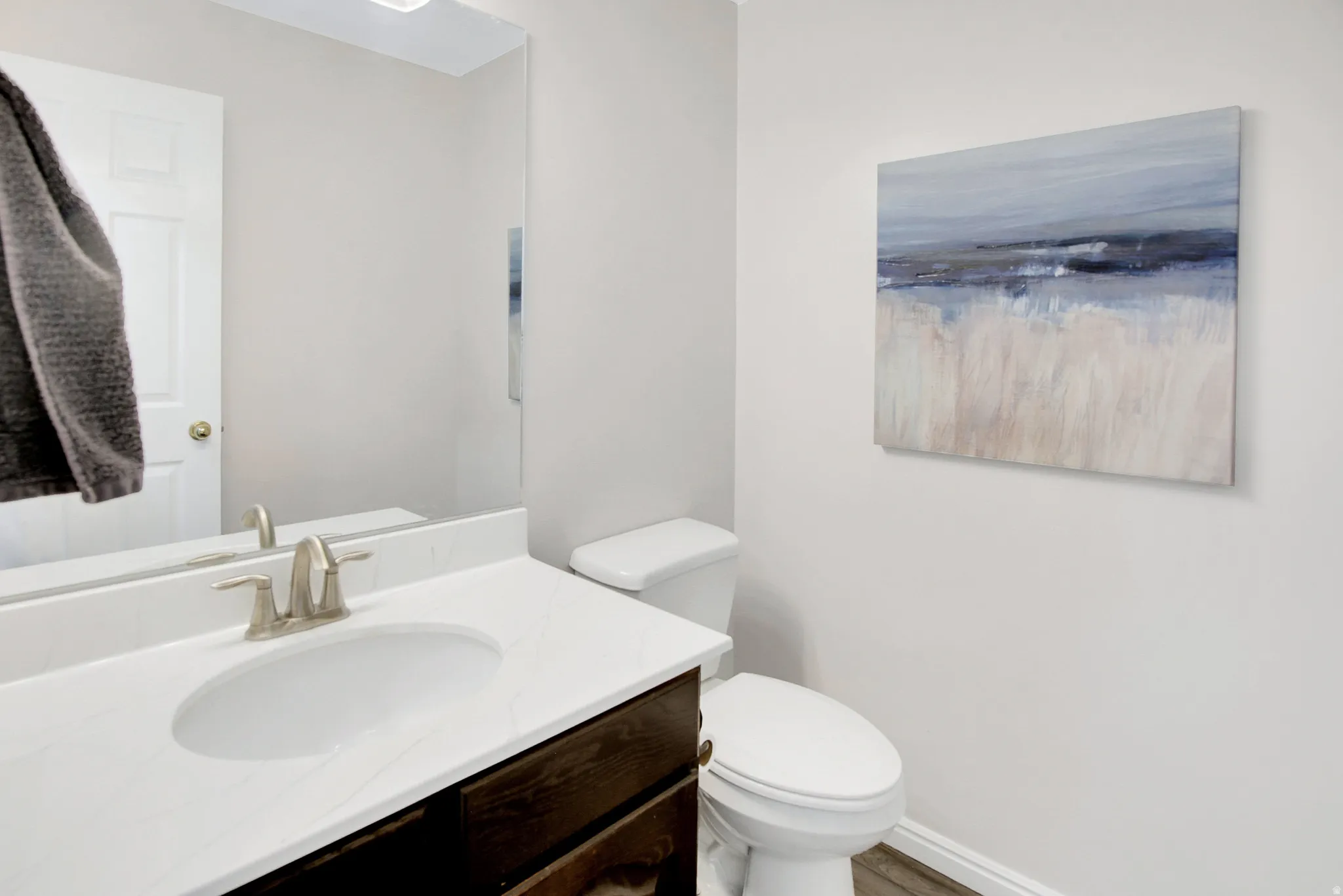 Half Bath located by great room. White solid surface countertop.