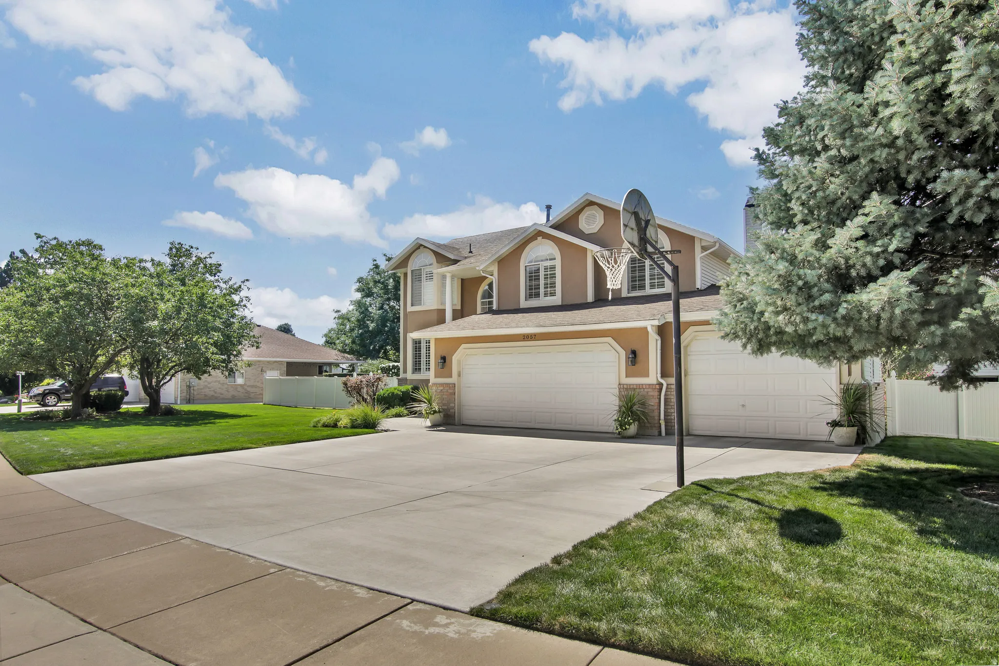 Angle view of home. Wide driveway and extra interior length in 3 Bay garage for TRUCKS!
