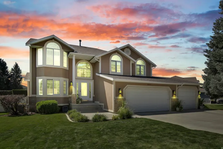 Stucco exterior with arched windows, prominent front entry with brick accents, and a Three car garage. One bay extra deep for a Truck!