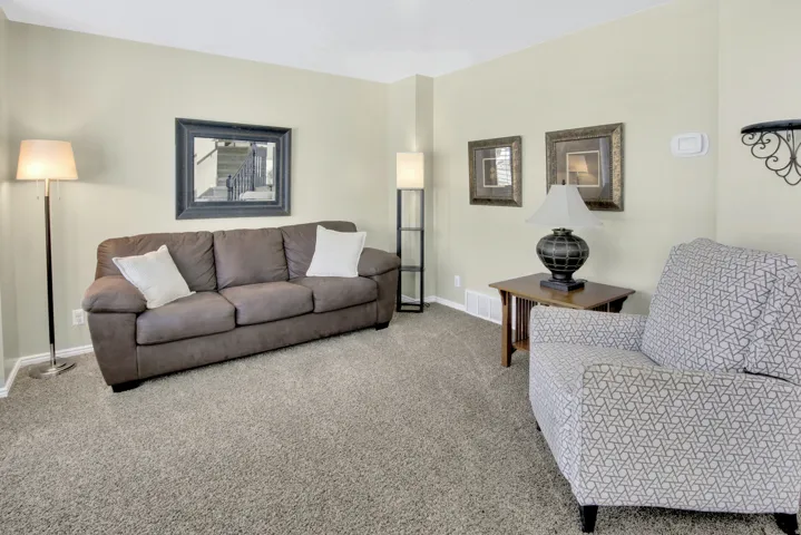 Carpeted flooring, light-toned wall paint, and white trim
