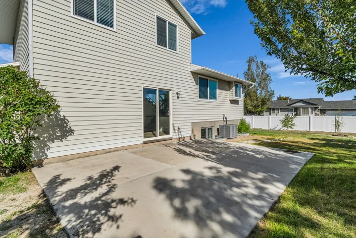 Expansive concrete patio with direct access via sliding glass door
