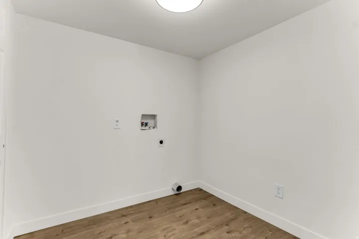 Wood-finish flooring with crisp white walls and ceiling