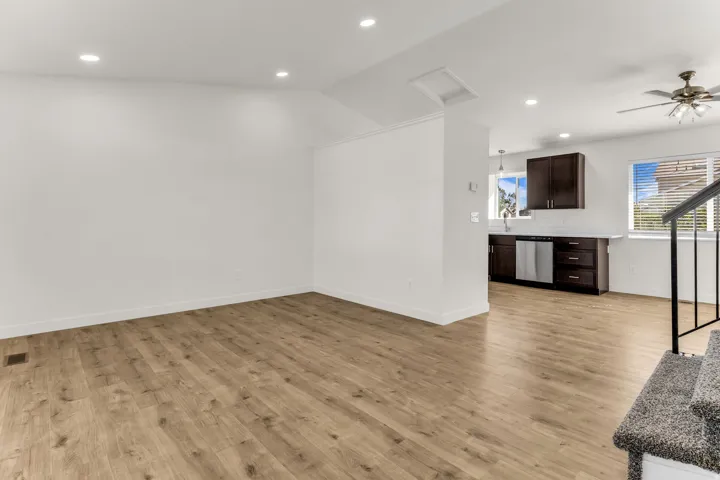 Wood-finish flooring throughout, recessed lighting, and a ceiling fan