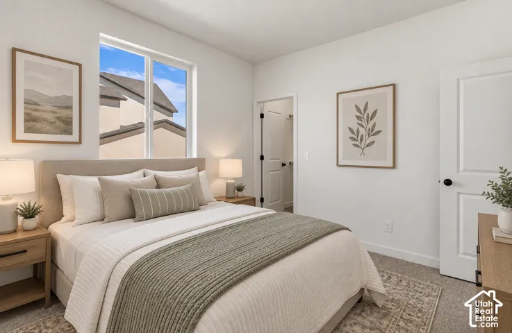 Carpeted bedroom featuring a large window, neutral wall paint, and a built-in closet with a panel door