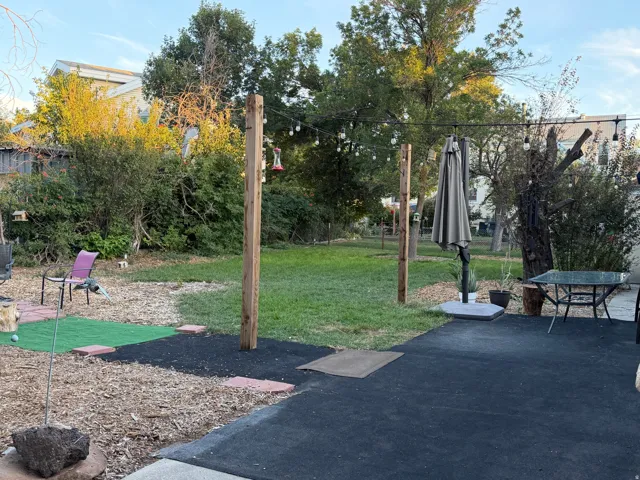 Expansive outdoor area featuring a paved patio and a grass lawn