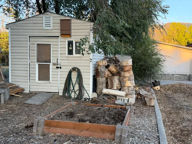 Shed with horizontal siding, a single window, and a louvered vent
