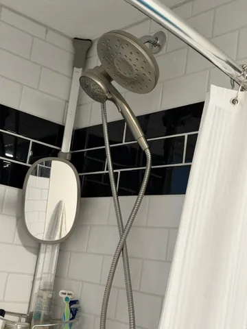 Subway tile shower surround with black accent tile