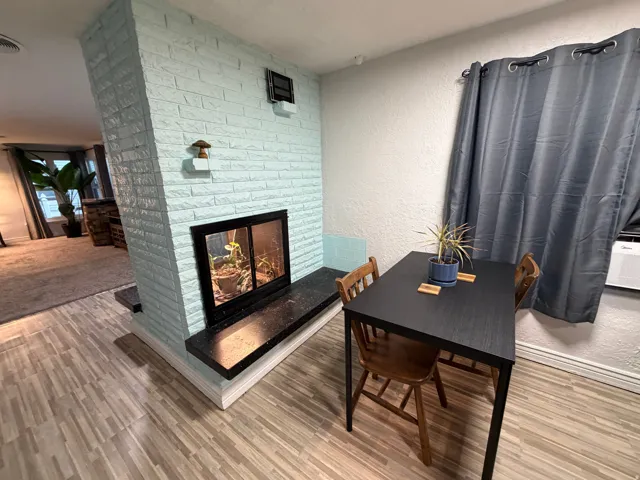 Central brick fireplace with a black firebox and hearth