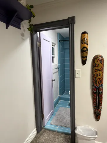 Bathroom featuring blue tile flooring and subway tile shower surround