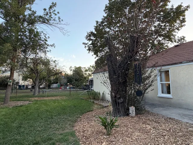Expansive yard with mature trees and a manicured lawn