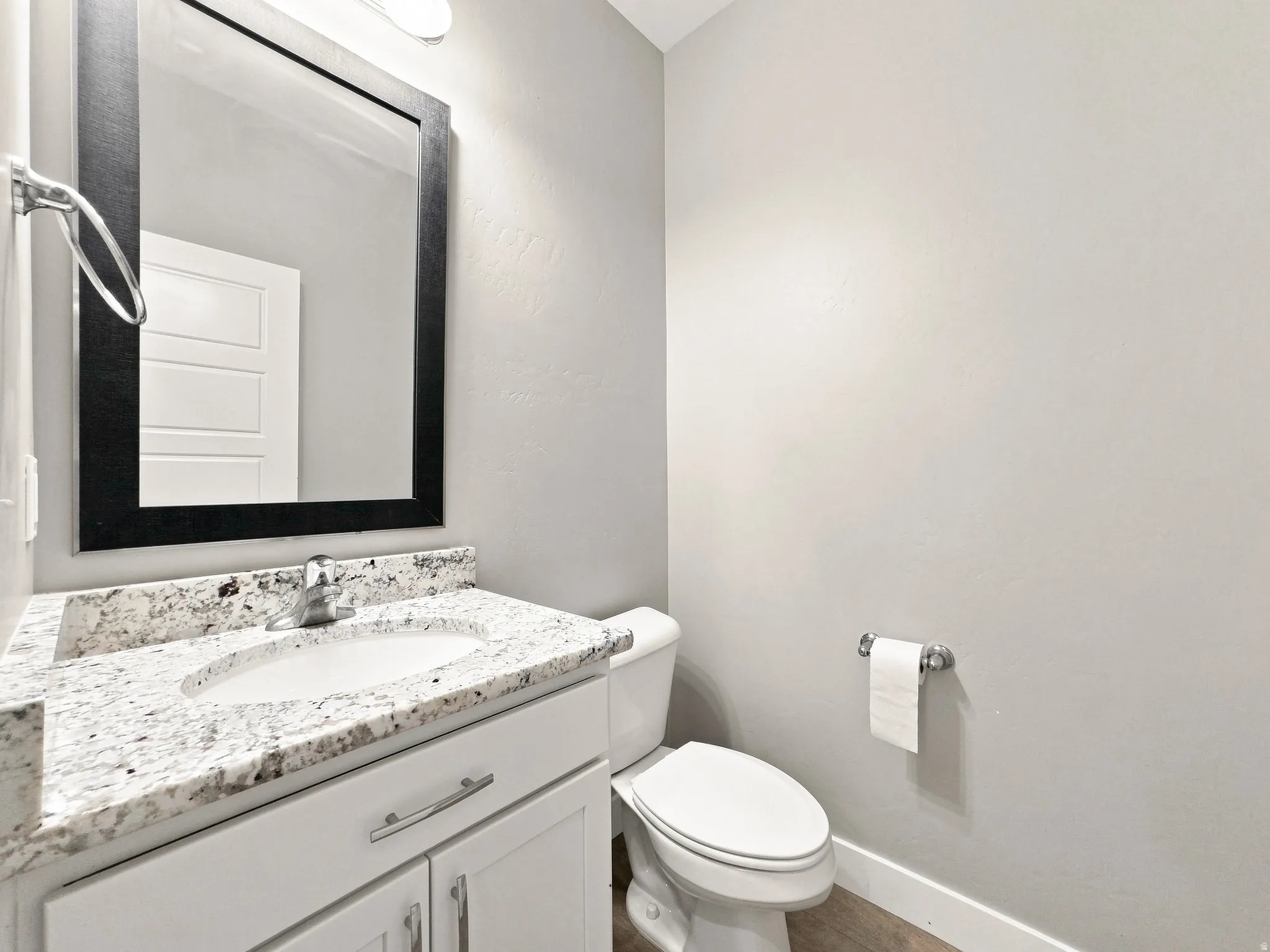 Vanity with granite countertop, undermount sink, and chrome faucet