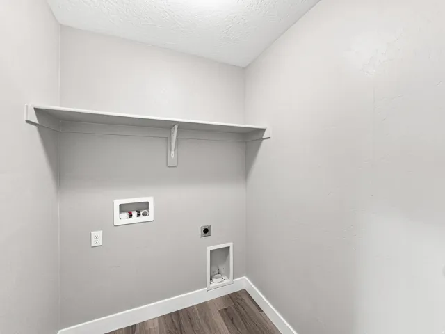 Utility area featuring wood-finish flooring and a built-in storage shelf