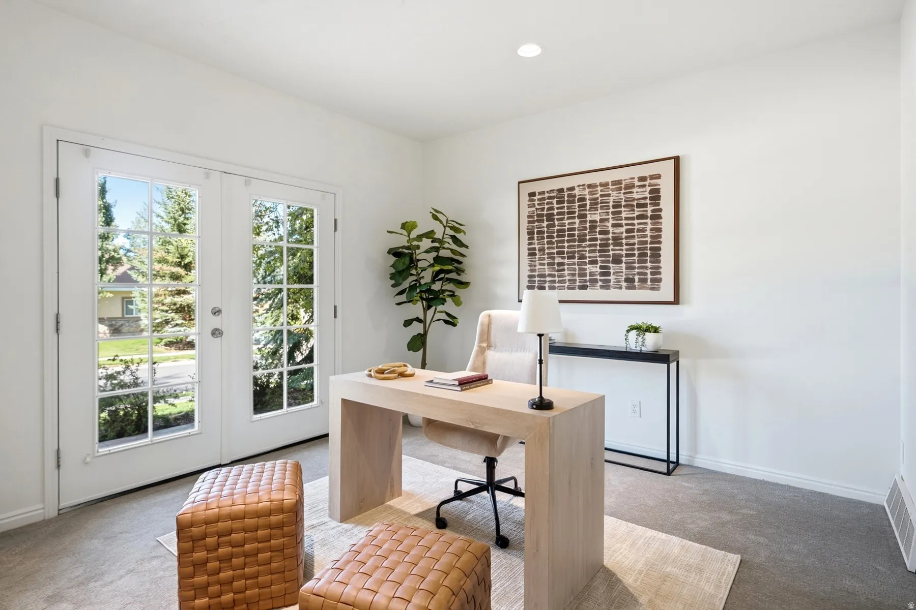 White walls with recessed lighting and gray carpeting