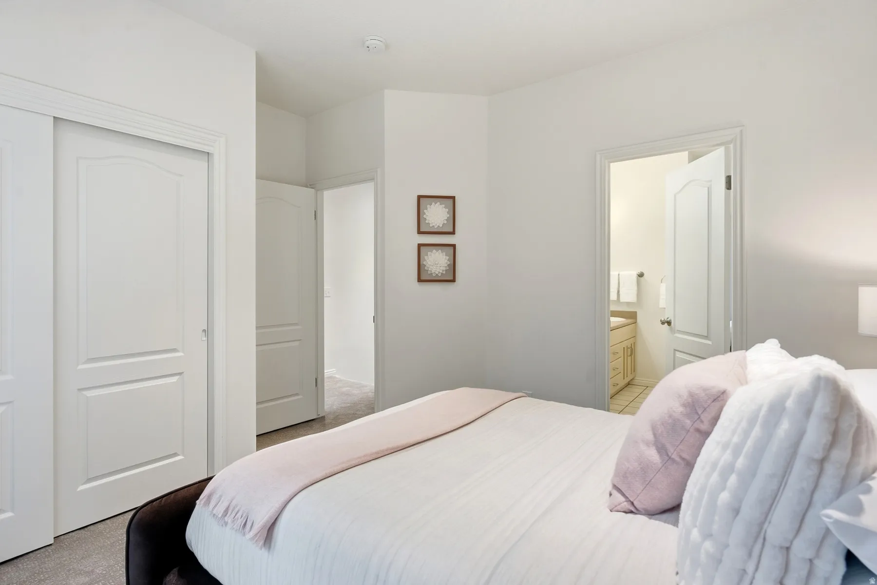 Recessed lighting, light-colored walls, white interior doors, and carpeted flooring