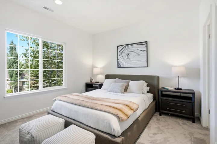 Expansive window with grid panes, recessed ceiling lighting, light neutral wall finishes, and light neutral carpet