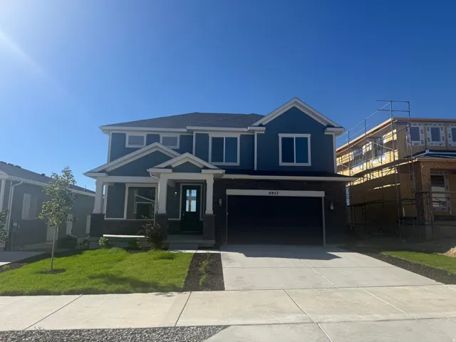 Contemporary two-story exterior with blue siding and stone accents