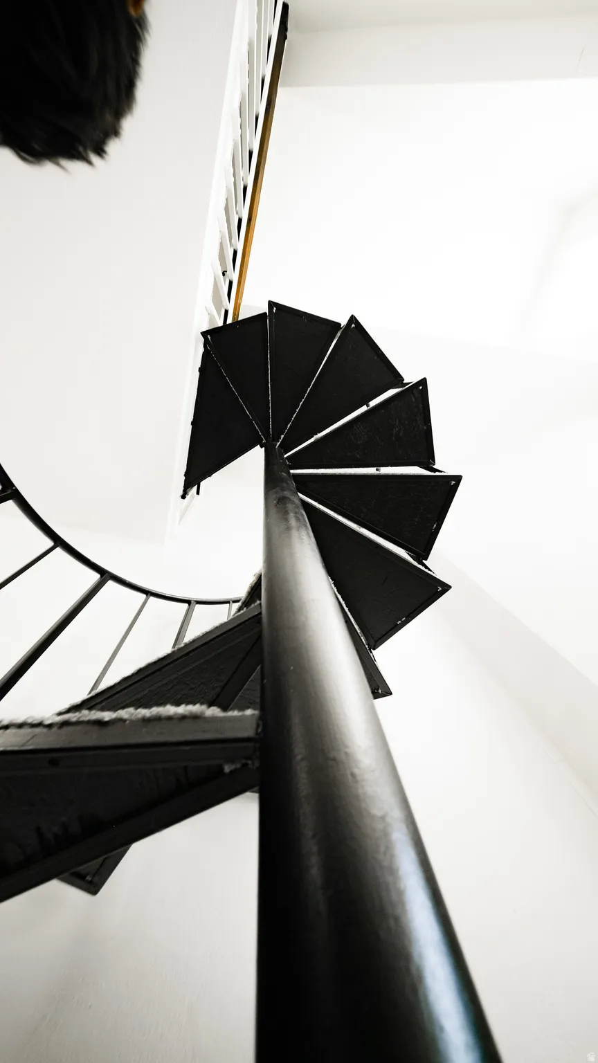 Black metal spiral staircase with a central support column