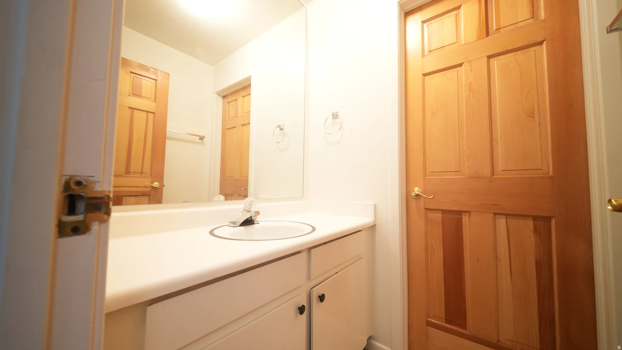 Vanity with an integrated sink, polished chrome faucet, and white cabinetry