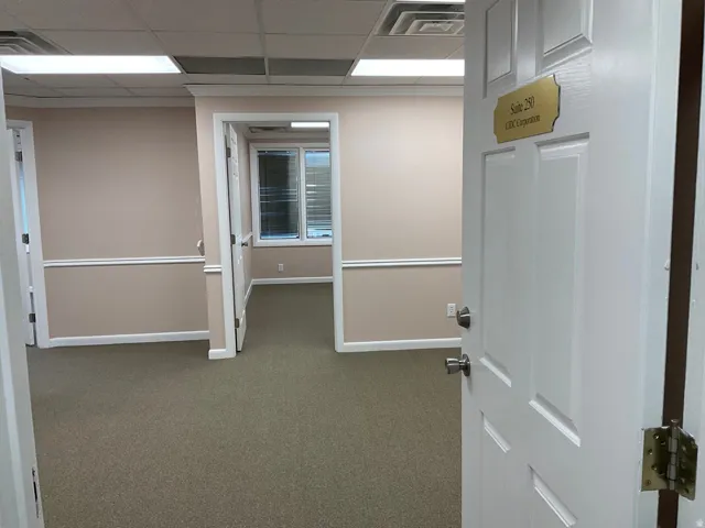 Carpeted flooring, neutral wall tones, white trim, recessed lighting, and an interior window
