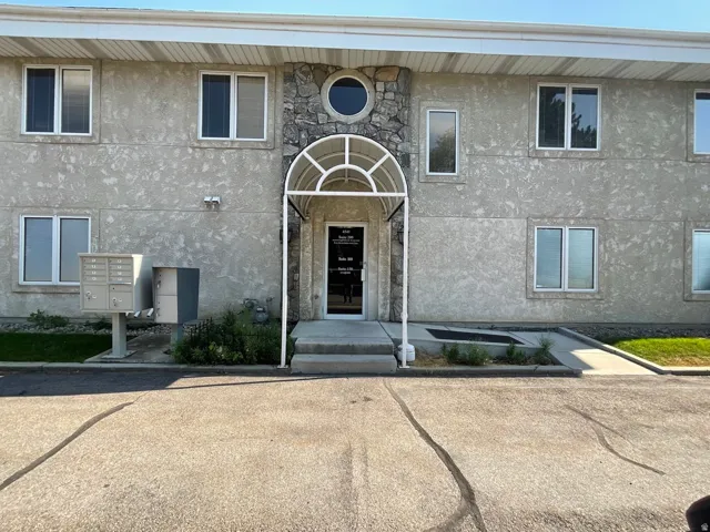 Stucco exterior with stone accents and multiple windows