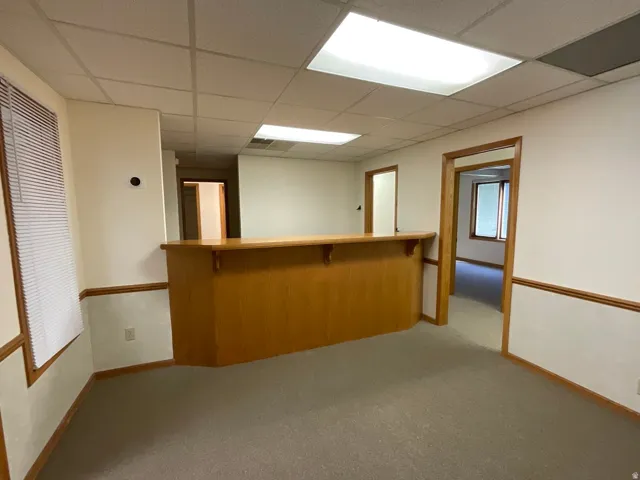 Carpeted interior with wood trim, a built-in counter, and multiple doorways